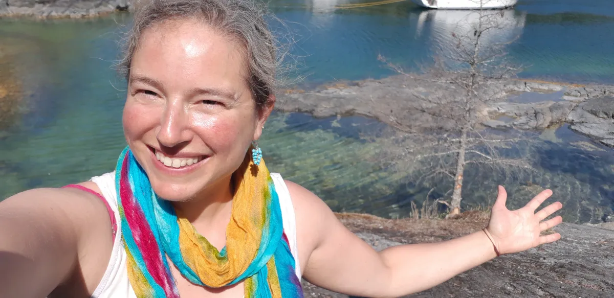 Marni Levitt smiling and enjoying a peaceful moment surrounded by nature.